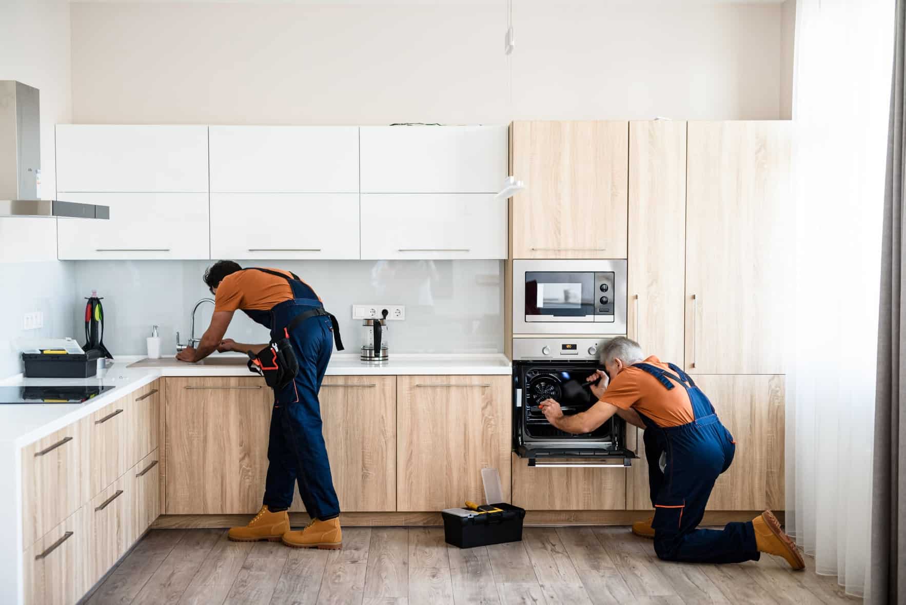 Electrician installing modern lighting fixtures and wiring in a well-designed home interior.