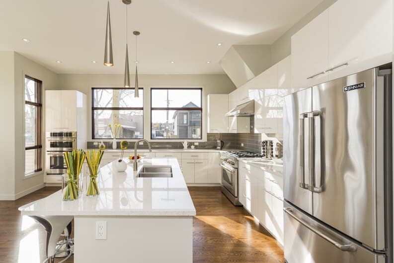 Bright modern kitchen with stainless steel appliances and white cabinetry, representing kitchen remodeling in Irvine