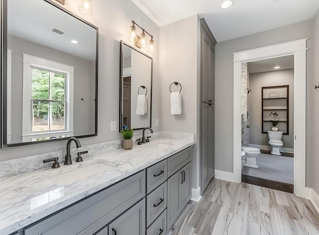 Bathroom remodeling in Mission Viejo with double vanity and marble countertops.